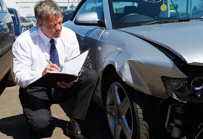 man reviewing car insurance policy on tablet